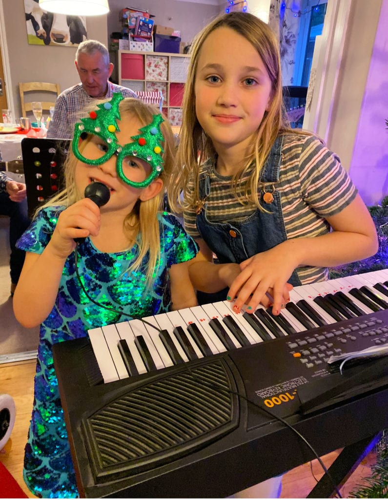 Aria with her concert singing and playing the keyboard in Christmassy clothes