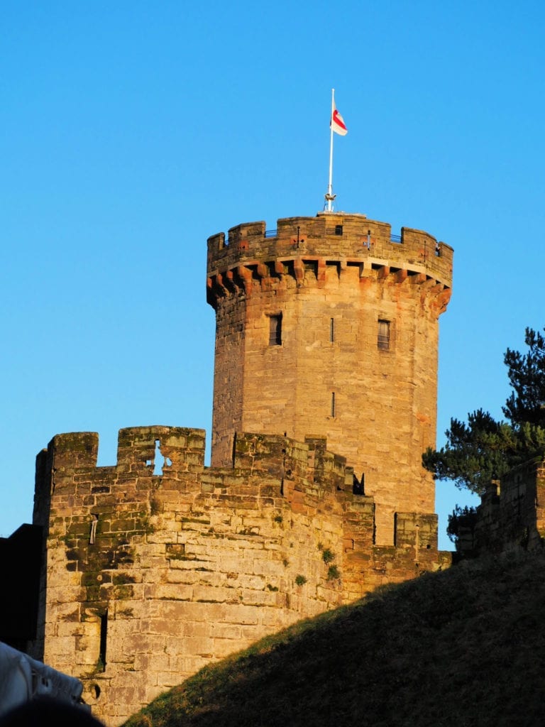 Picture of a turret flying the English flag at Warwick Castle